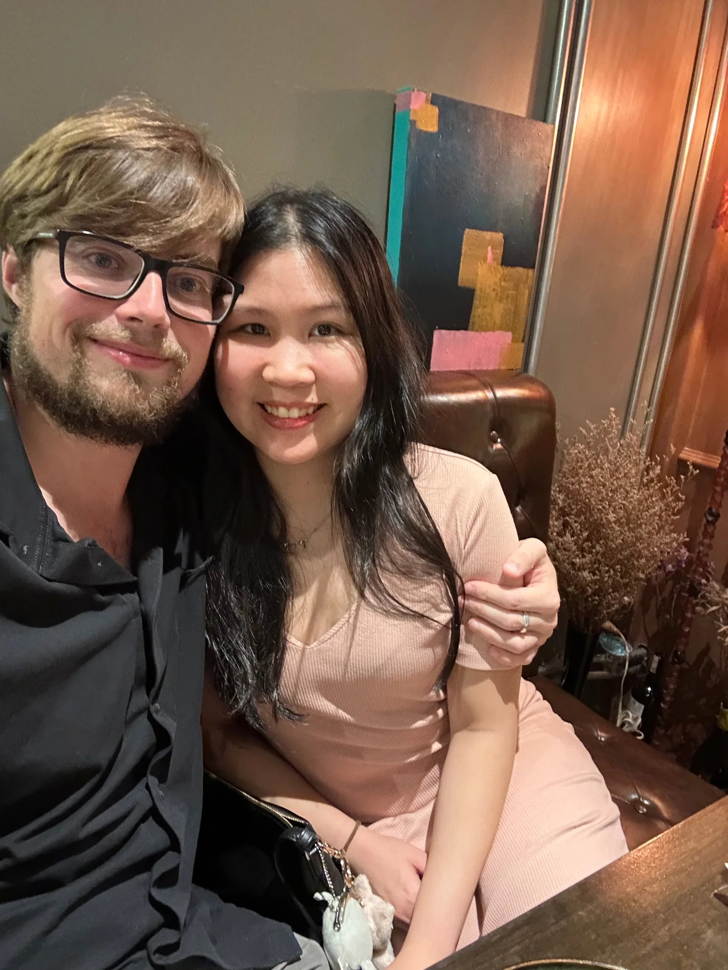 Lewis and Gail smiling close together over dinner.