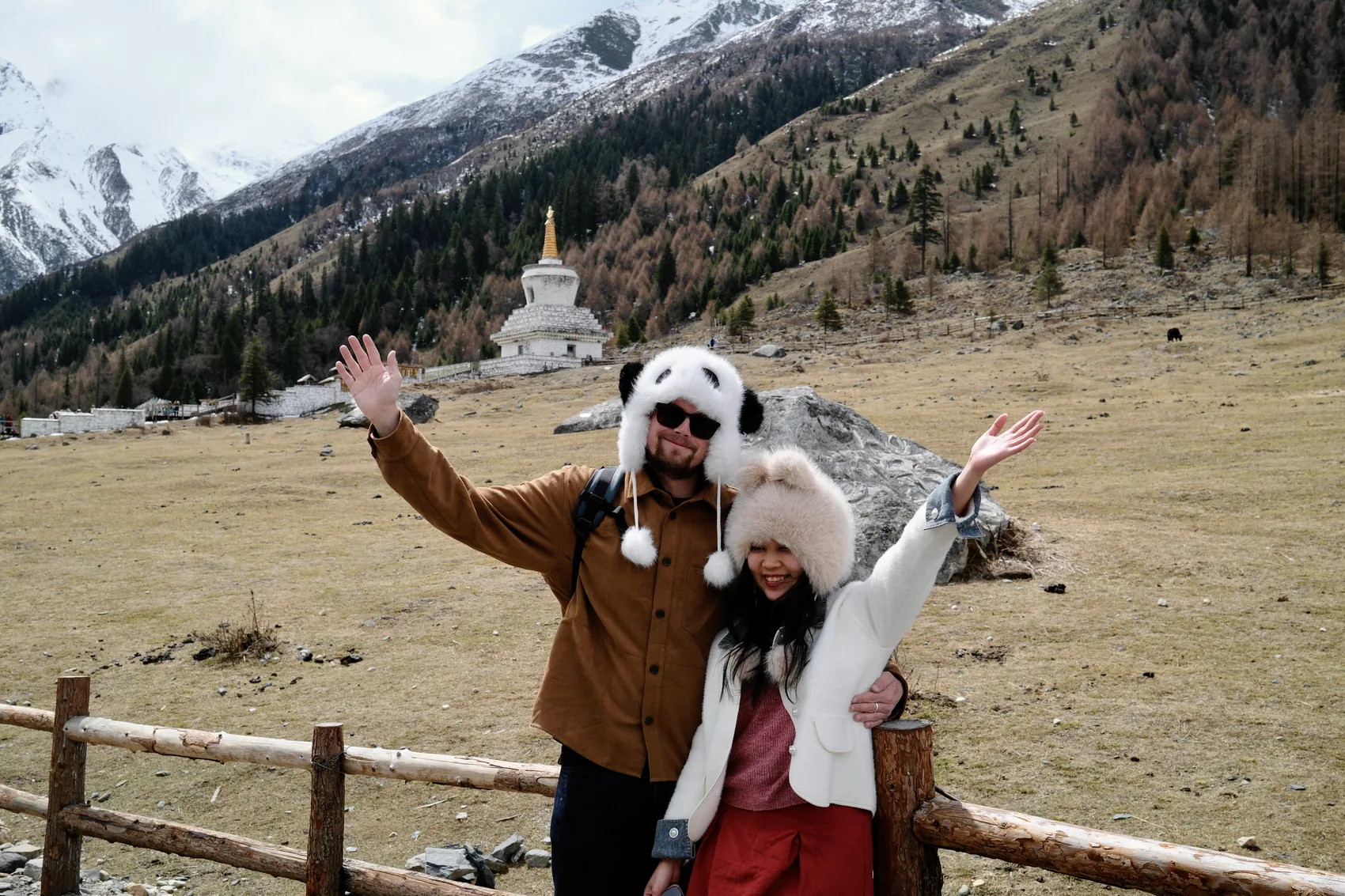 Lewis and Gail together in snowy mountains wearing fuzzy hats.
