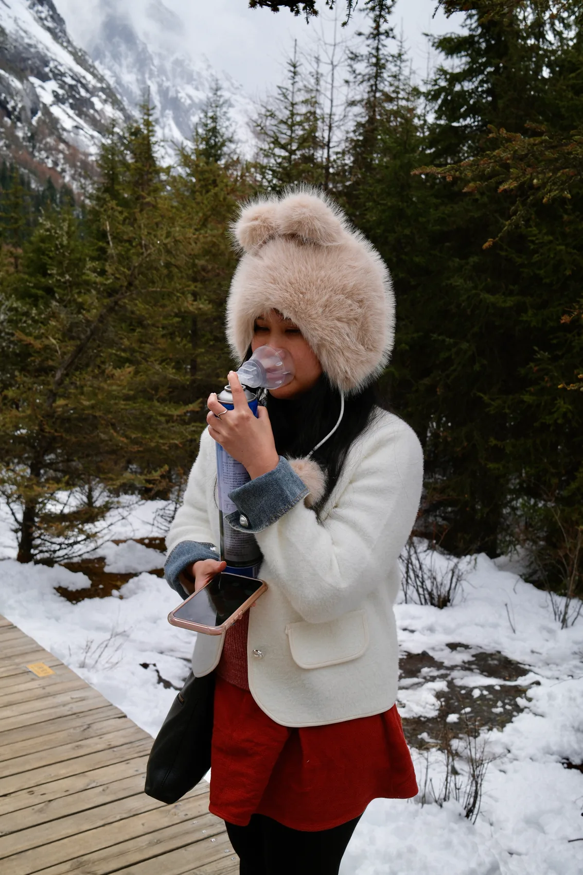 Gail enjoying a warm drink in the snow.