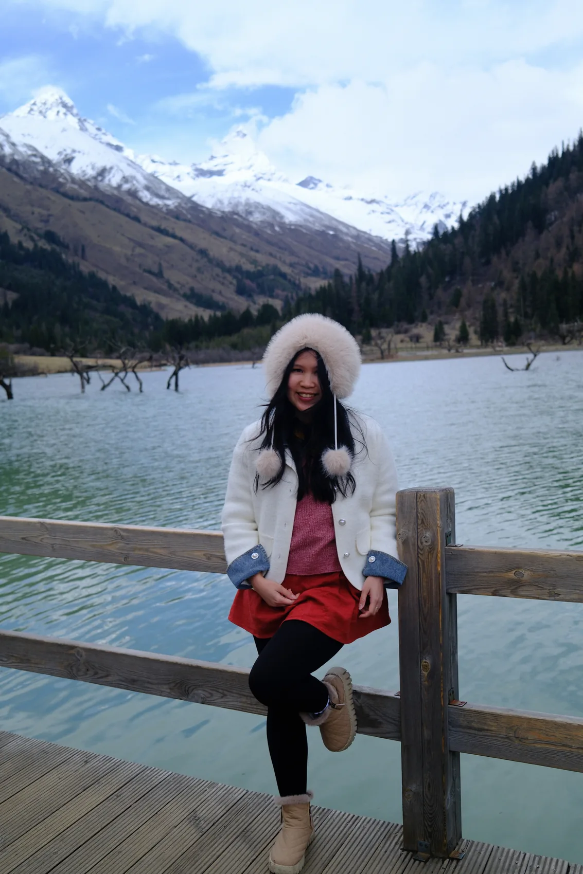 Gail standing beside a mountain lake.