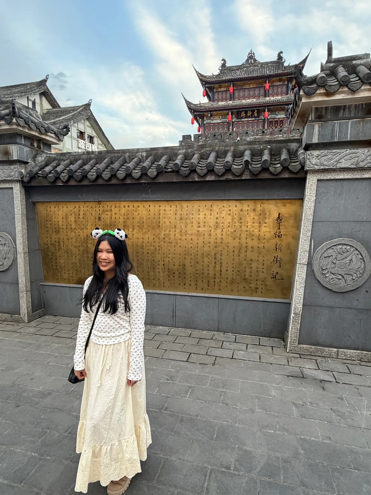 Gail smiling in front of a historic wall.