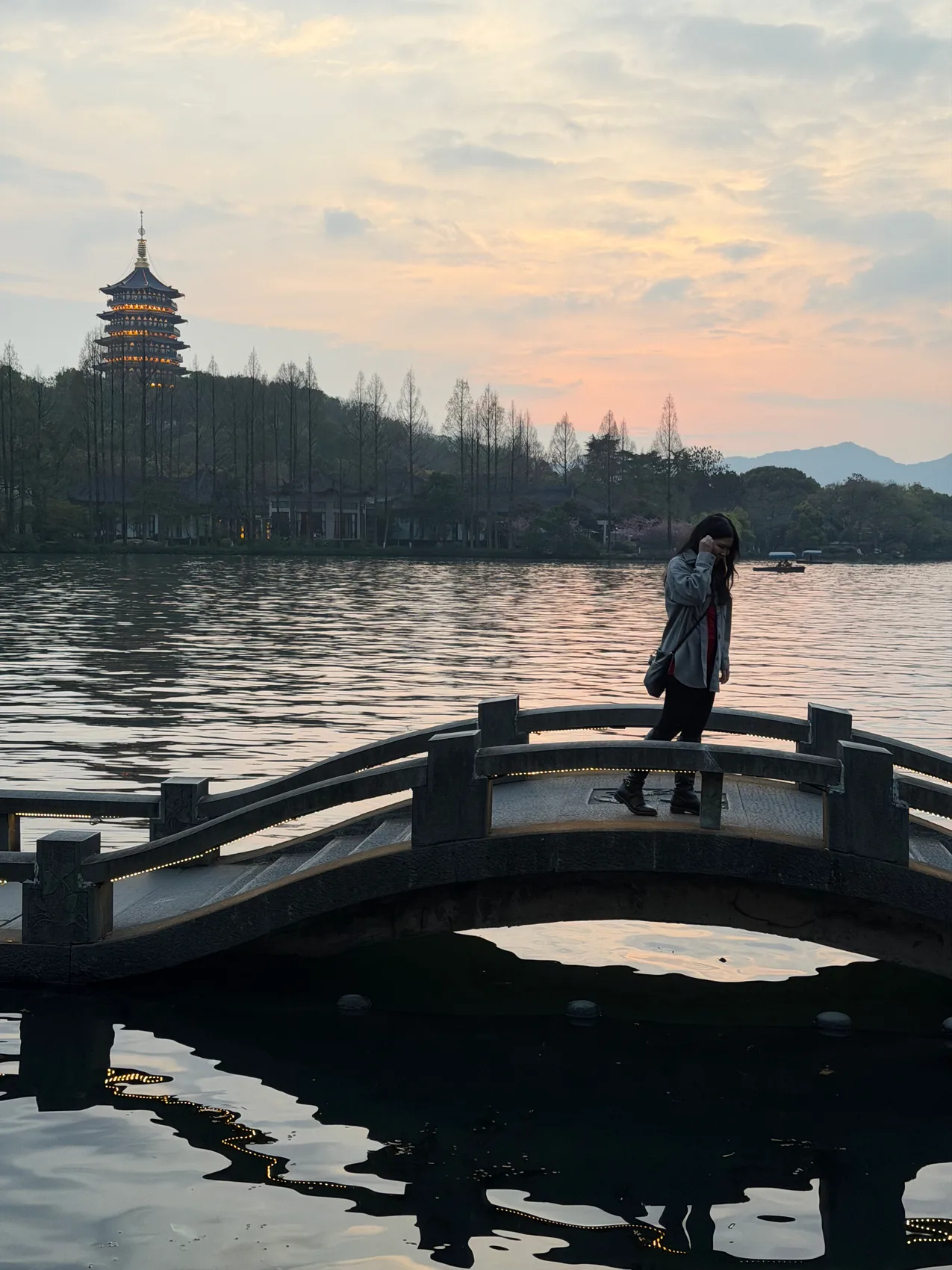 Gail standing on a wooden platform beside a lake.