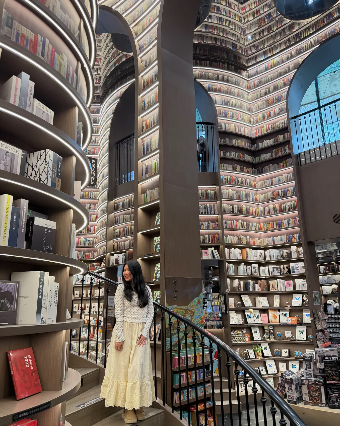 Gail looking up inside a tall library.