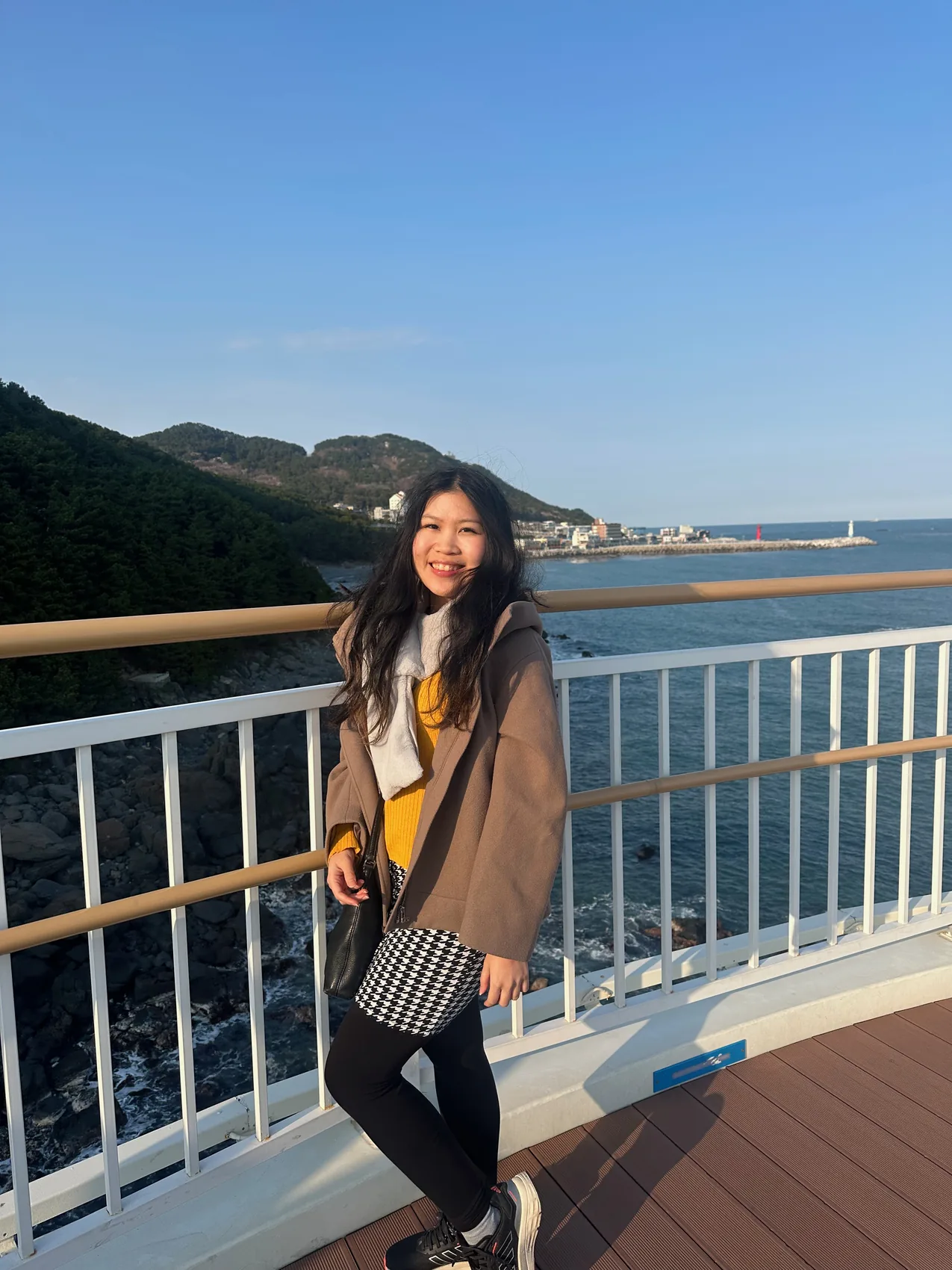 Gail smiling beside the sea.