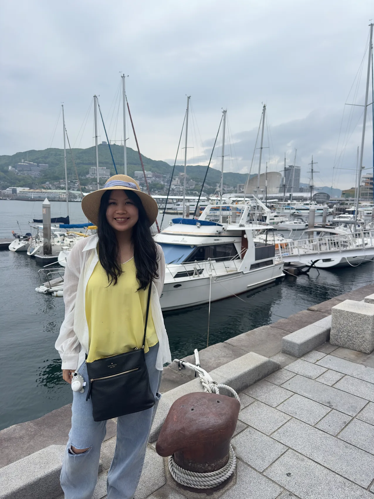 Gail smiling beside a marina.