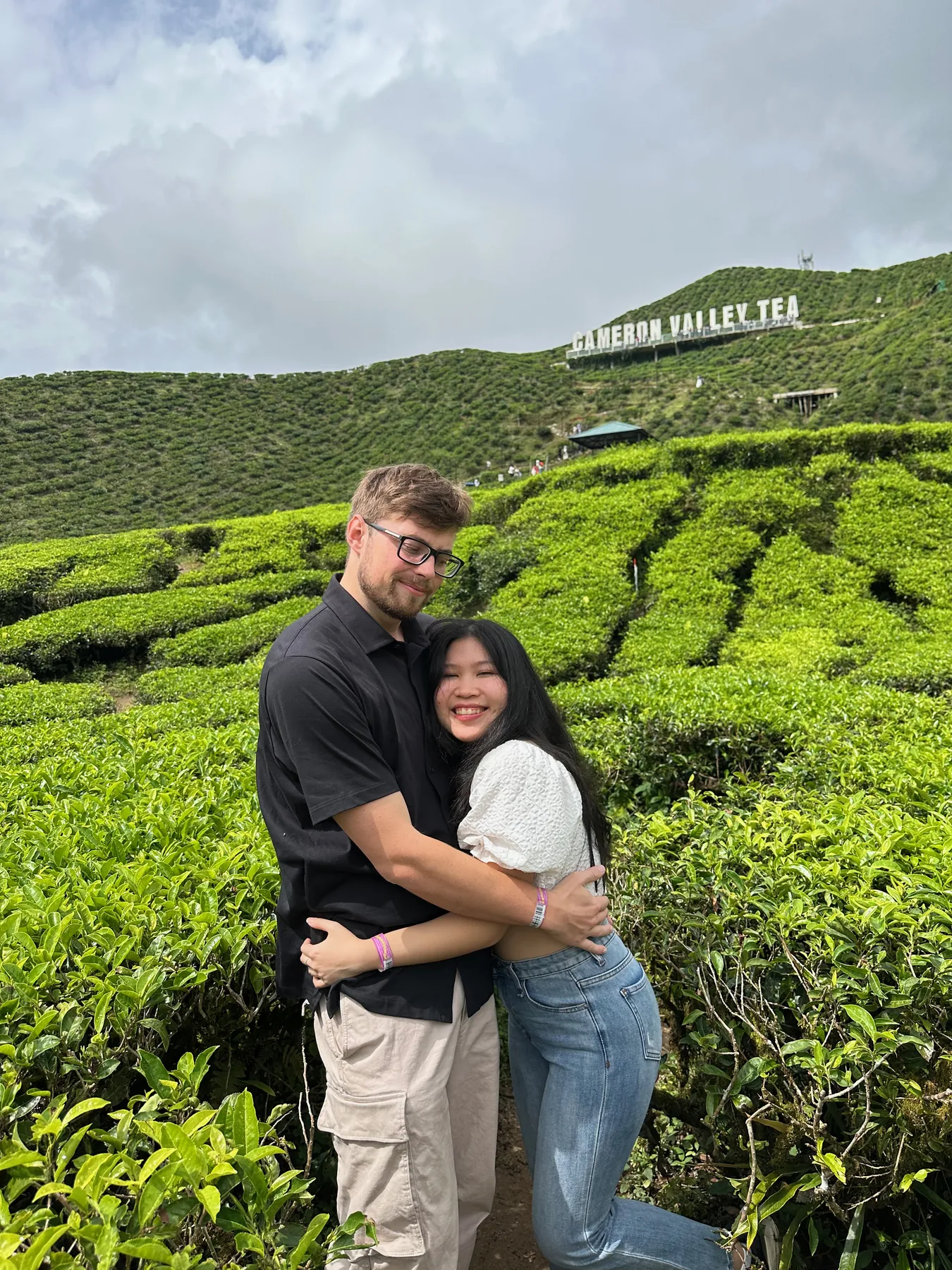 Lewis and Gail hugging in a green tea plantation.