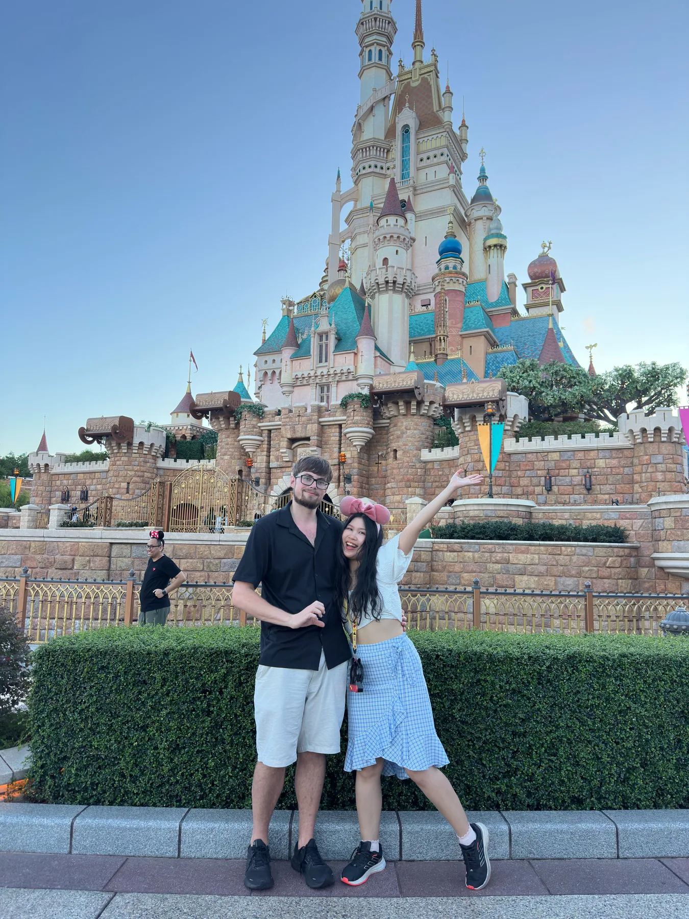 Gail leaning into Lewis in front of a fairytale castle.
